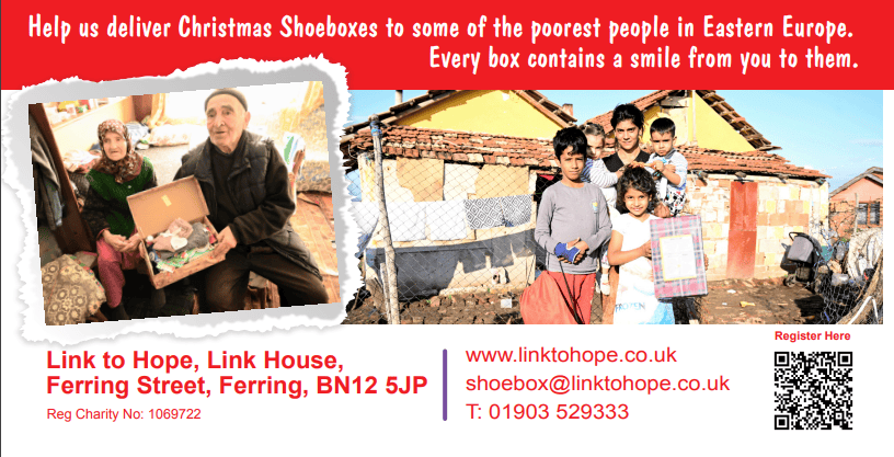 An elderly couple holding Christmas shoebox gifts, smiling, with a backdrop of modest homes. Children stand nearby, showcasing joy and community spirit.
